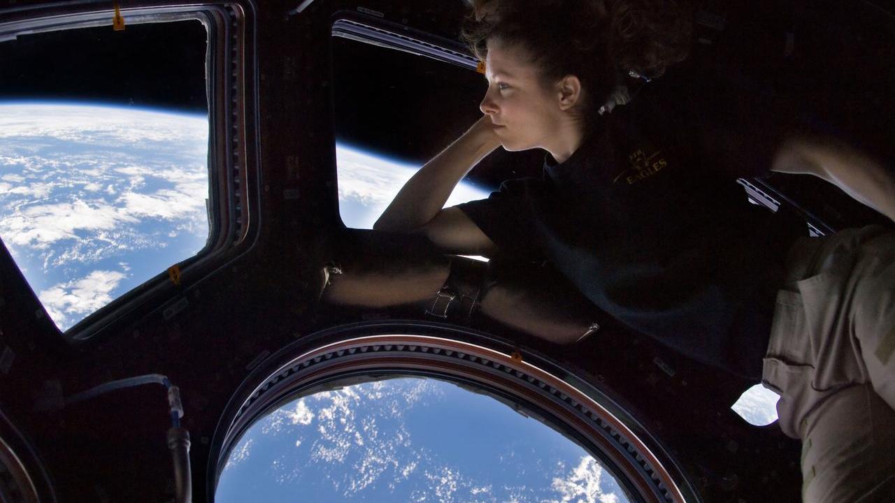 NASA astronaut Tracy Caldwell Dyson, Expedition 24 flight engineer, looks through a window in the Cupola of the International Space Station. 