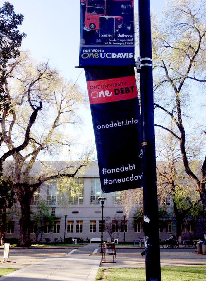 "One Debt" banner, art exhibition class 