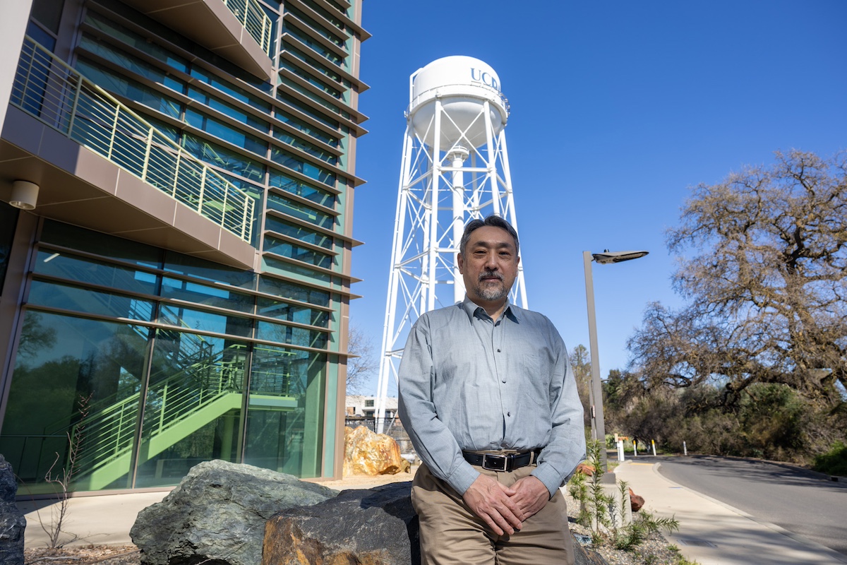 Motani poses outside of the Earth and Planetary Sciencs Building with the UC Davis water tower in the background. 
