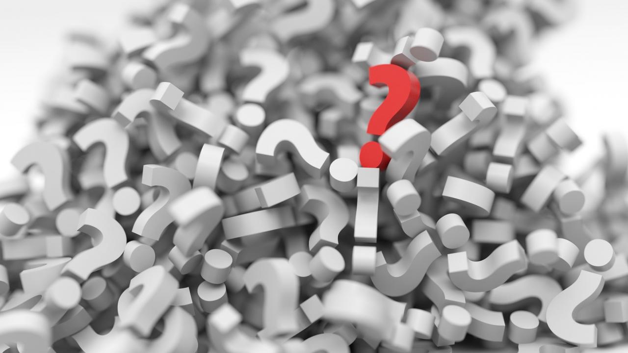 Photo illustration: pile of question marks