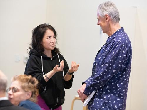 Andreas Andy Albrecht (right) smiles as UC Davis art graduate student Seong Min Yoo speaks with him